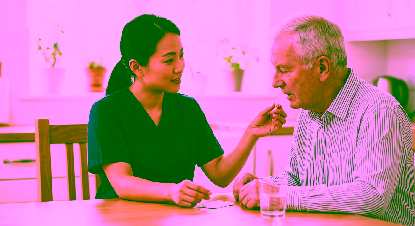 A Dendera Care carer supporting an older man with his medication